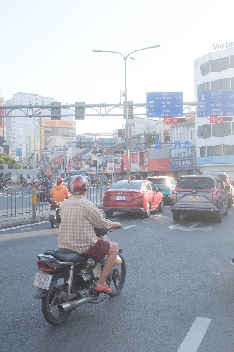 Edit city photo into rainy scene with Vietnamese bikers 1